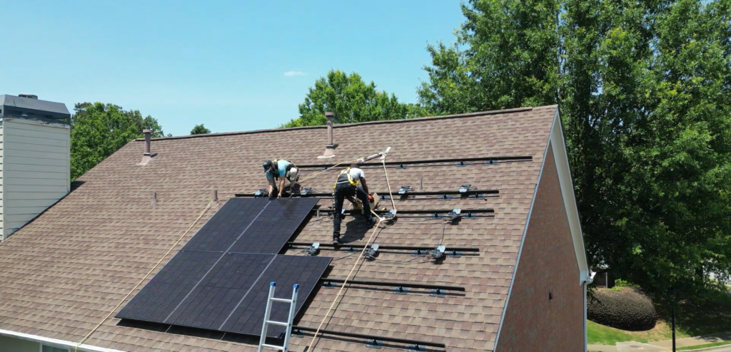 CSS workers on roof installing solar panels CSS workers on roof installing solar panels
